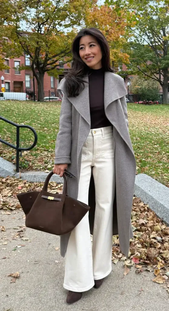 Grey Wrap Coat with Cream Wide-Leg Jeans, petite woman in grey wrap coat, dark turtleneck, cream wide-leg jeans and dark tote, outdoor park.